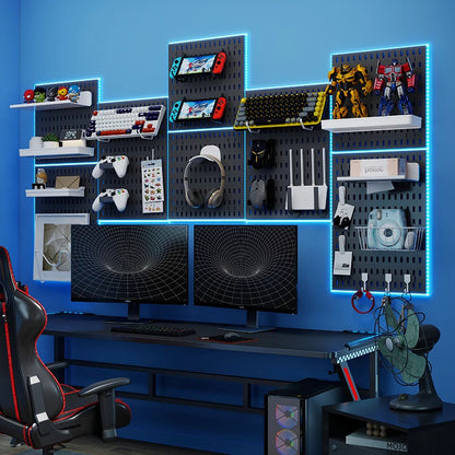 Gaming setup with monitors, chair, and shelves against a blue wall.