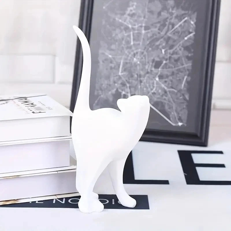 White cat figurine on a surface with a map in the background