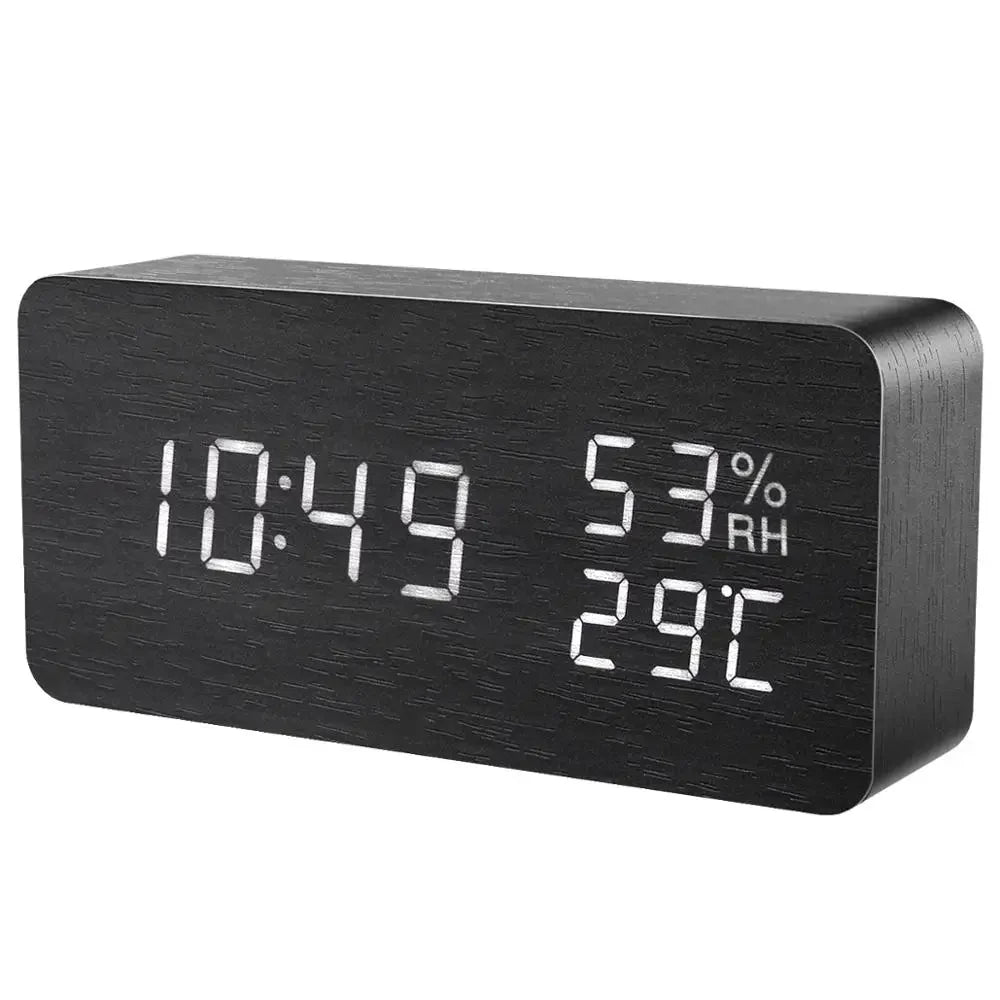Black digital clock with time, temperature, and humidity display on a white background