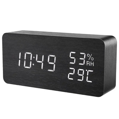 Black digital clock with time, temperature, and humidity display on a white background