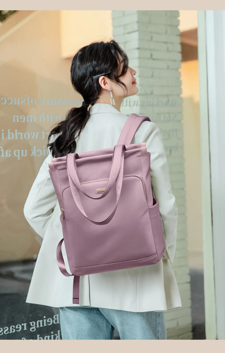 Person wearing a pink backpack in an indoor setting
