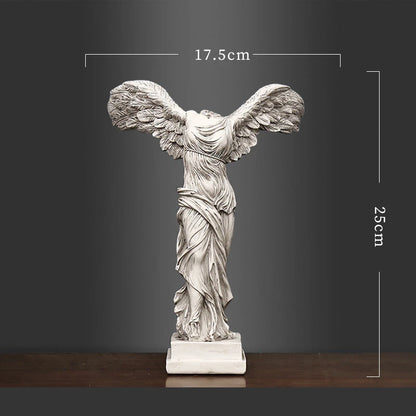 Statue of a winged figure with dimensions on a dark background