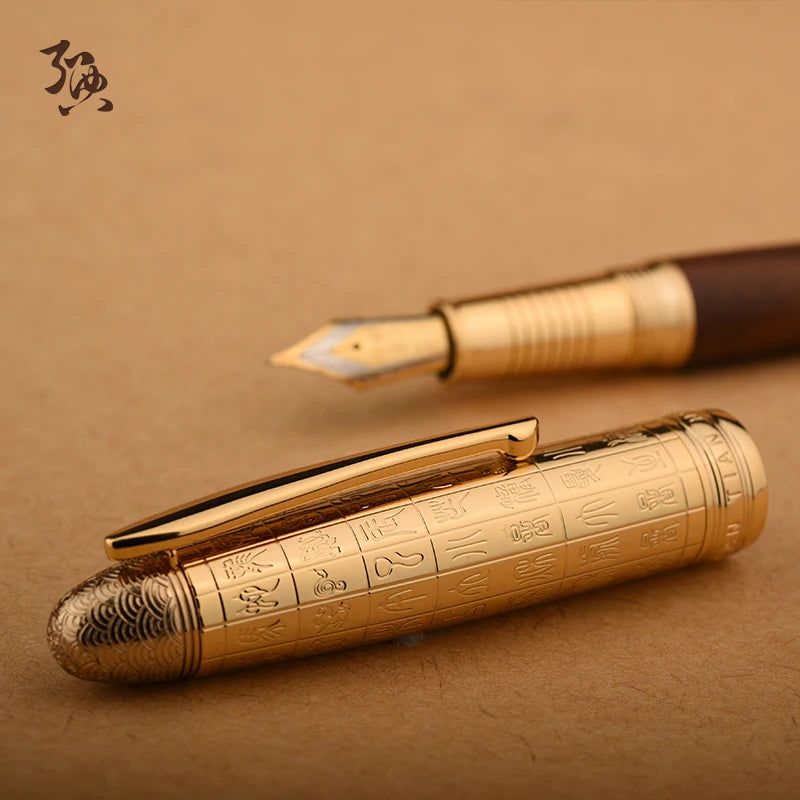 Gold pen with intricate designs on a brown background