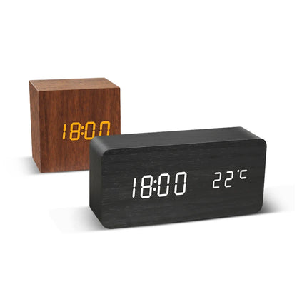 Two digital clocks, one wooden and one black, displaying time and temperature on a white background.