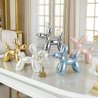 Decorative balloon dog sculptures in various colors on a marble surface.