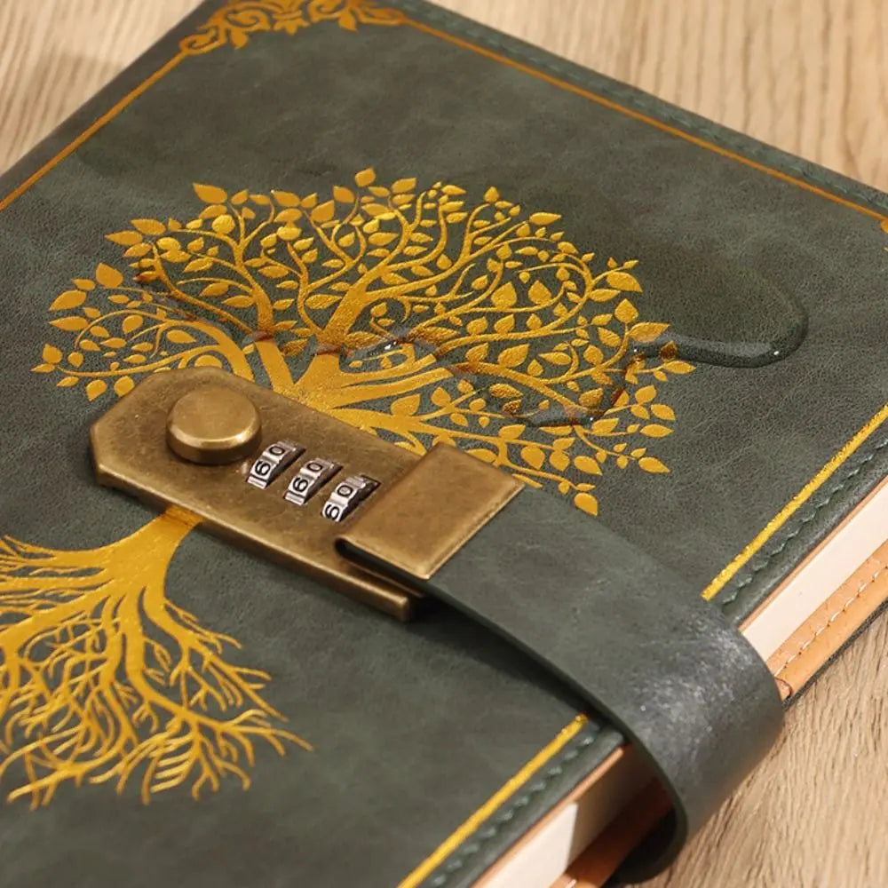 Green leather notebook with gold tree design and combination lock on a wooden surface