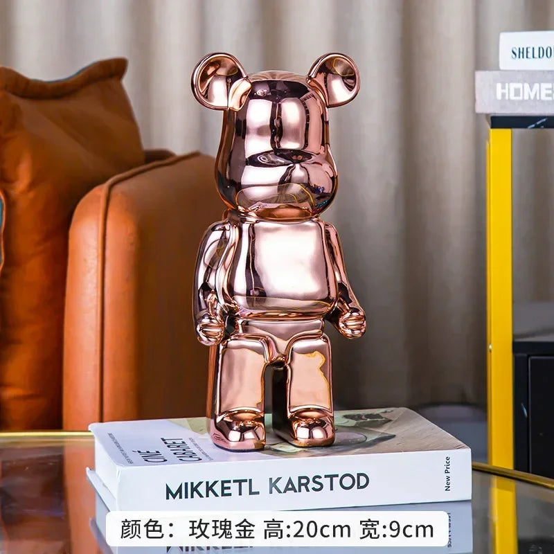 Rose gold bear-shaped decorative object on a book with a blurred background
