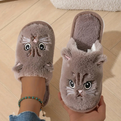 Cat-shaped slippers worn by a person on a wooden floor