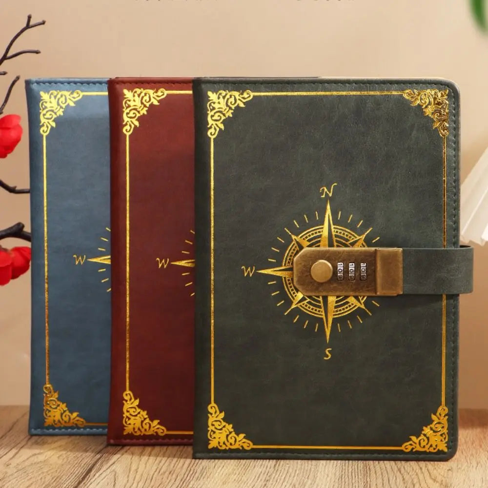 Three leather-bound books with compass designs on a wooden surface.