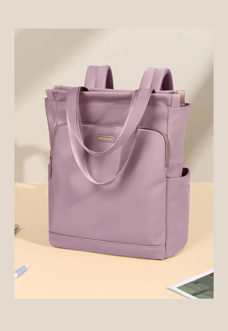 Purple tote bag with backpack straps on a beige surface