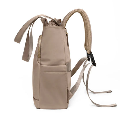 Beige backpack with multiple straps on a white background