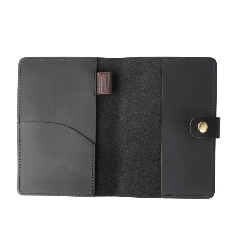 Black leather wallet with a button closure on a white background
