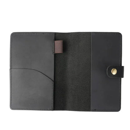 Black leather wallet with a button closure on a white background