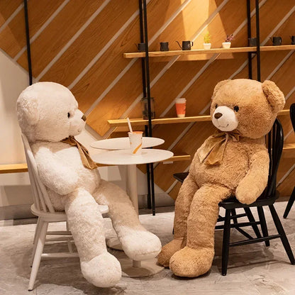 Two teddy bears sitting at a small table in a modern indoor setting.
